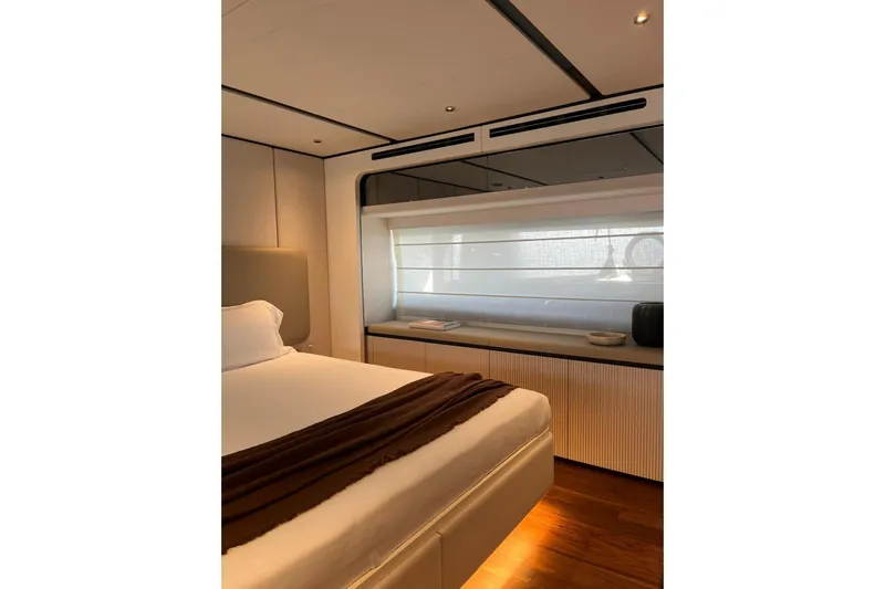  Yacht Photos Pics Luxurious bedroom interior of 2026 Ferretti Yachts 940 with modern design and ambient lighting.
