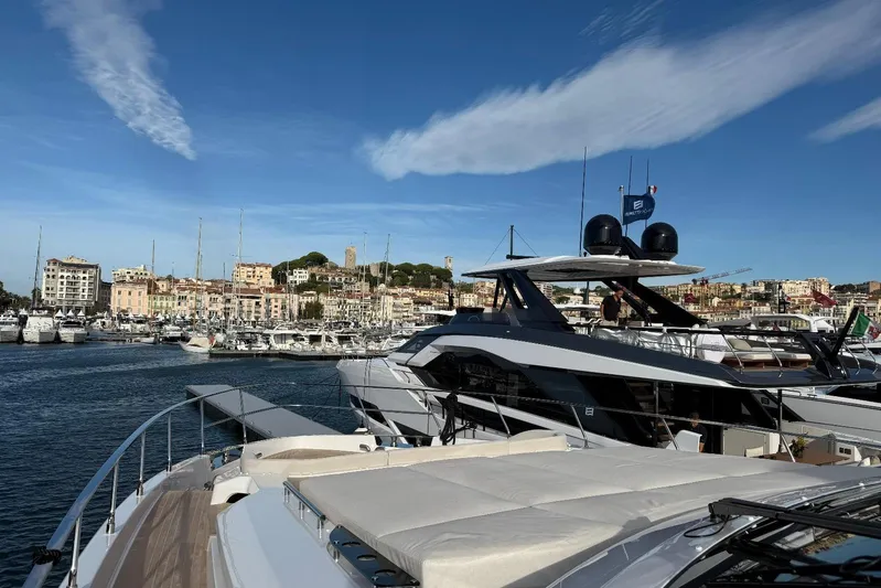  Yacht Photos Pics Luxurious 2026 Ferretti Yachts 940 docked in scenic marina under clear blue sky.