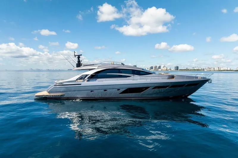  Yacht Photos Pics 2022 Pershing 8X yacht on calm ocean with city skyline in background.