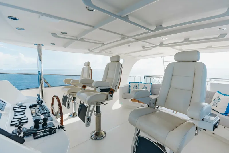 Aurelia Yacht Photos Pics Luxurious 2007 President Tri-Deck yacht helm with plush seating and ocean view.