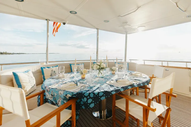 Aurelia Yacht Photos Pics Luxurious dining setup on 2007 President Tri-Deck yacht with ocean view.