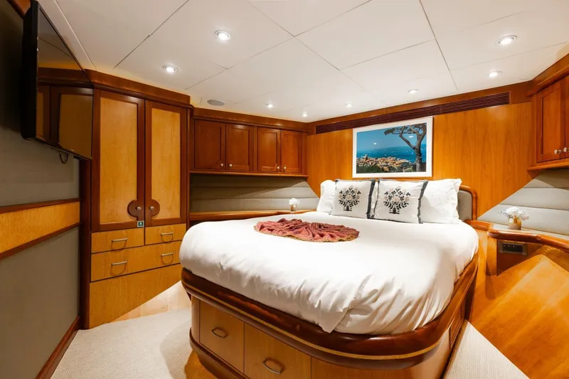 Aurelia Yacht Photos Pics Luxurious bedroom interior on 2007 President Tri-Deck yacht with elegant wood finishes.