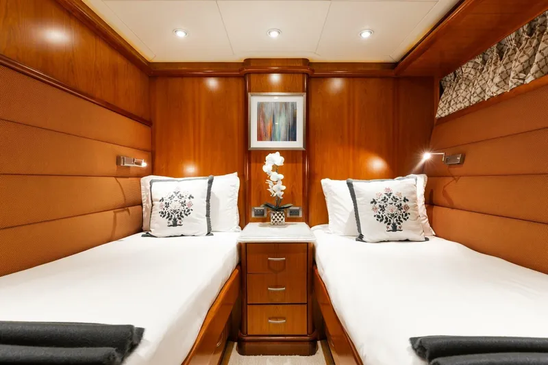 Aurelia Yacht Photos Pics Luxurious 2007 President Tri-Deck yacht cabin with twin beds and elegant wood paneling.