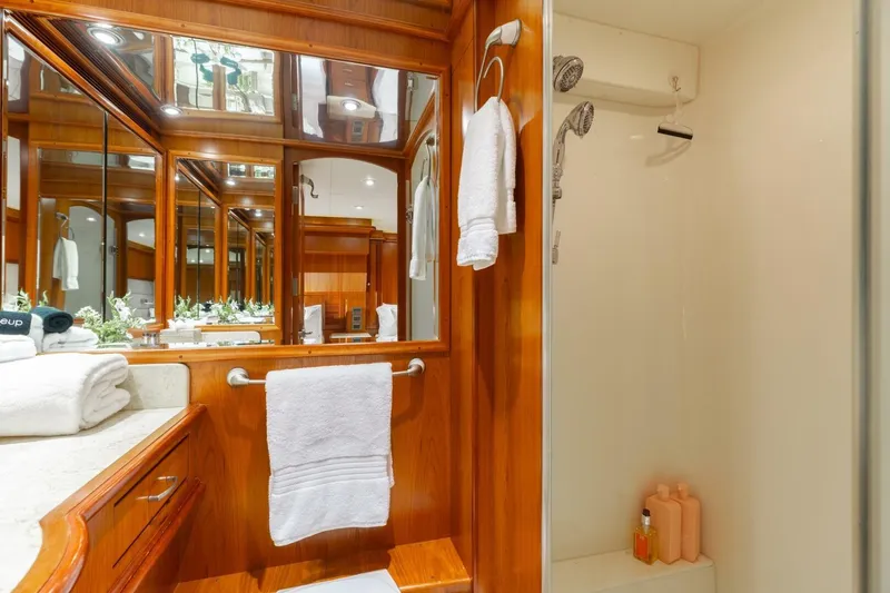 Aurelia Yacht Photos Pics Luxurious bathroom on 2007 President Tri-Deck yacht with wood accents and modern amenities.