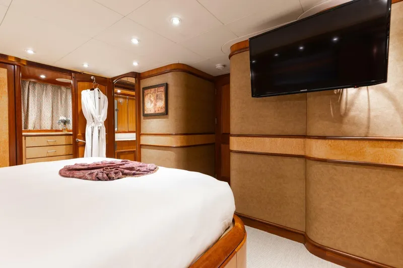 Aurelia Yacht Photos Pics Luxurious bedroom interior on 2007 President Tri-Deck yacht with TV and robe.