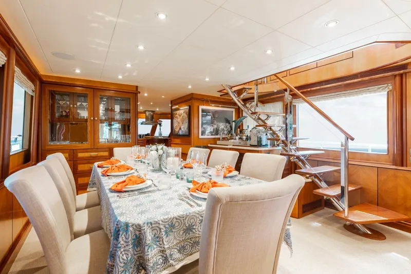Aurelia Yacht Photos Pics Luxurious dining area on a 2007 President Tri-Deck yacht with elegant table setting.