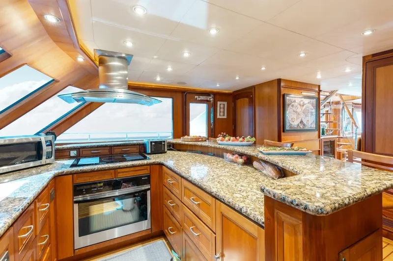 Aurelia Yacht Photos Pics Luxurious 2007 President Tri-Deck yacht kitchen with granite countertops and modern appliances.