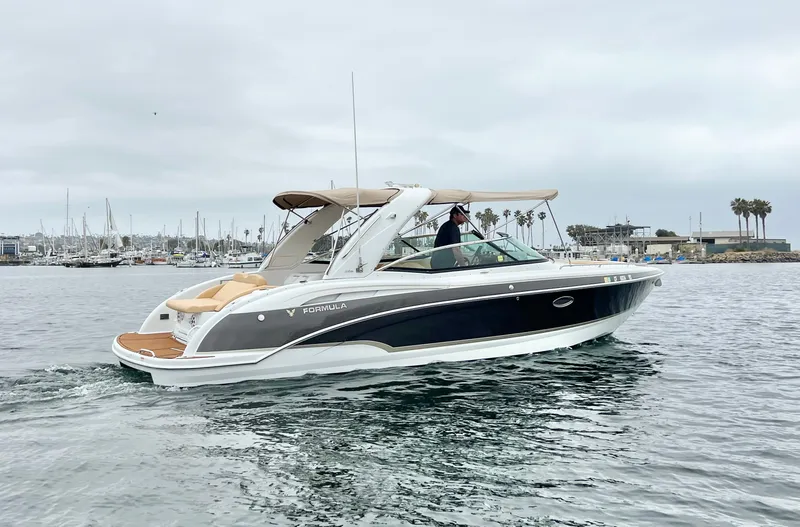  Yacht Photos Pics 2009 Formula 310 BR boat cruising in a marina with overcast skies.