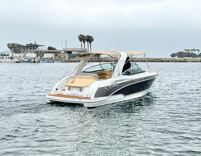  Yacht Photos Pics 2009 Formula 310 BR boat cruising near a marina with palm trees in the background.