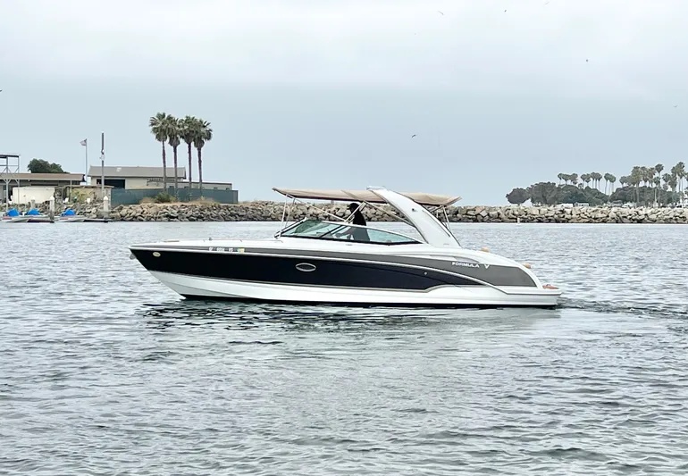 Yacht Photos Pics 2009 Formula 310 BR boat cruising on calm water near a coastal area.
