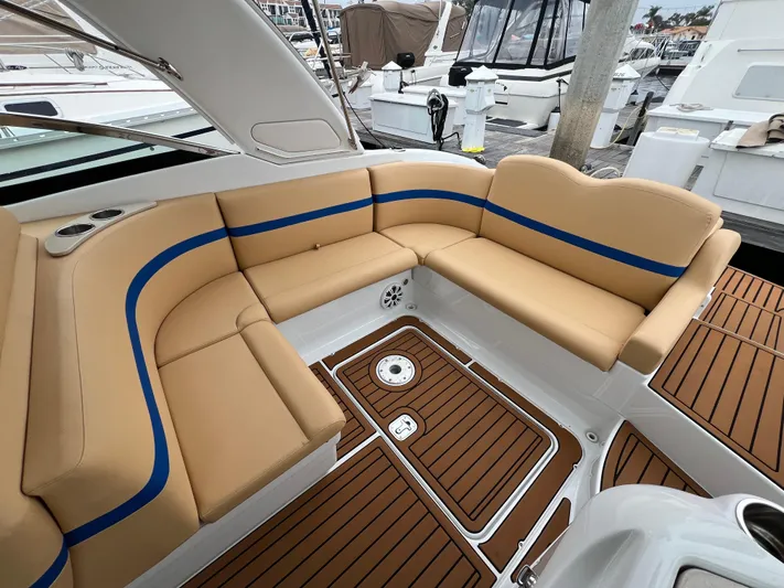  Yacht Photos Pics Luxurious 2009 Formula 310 BR boat interior with tan seating and blue accents at a marina.