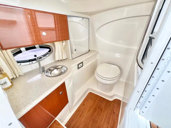  Yacht Photos Pics Luxurious 2009 Formula 310 BR boat bathroom with wood accents and modern fixtures.