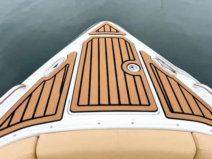  Yacht Photos Pics Bow of 2009 Formula 310 BR boat with teak-style decking on calm water.