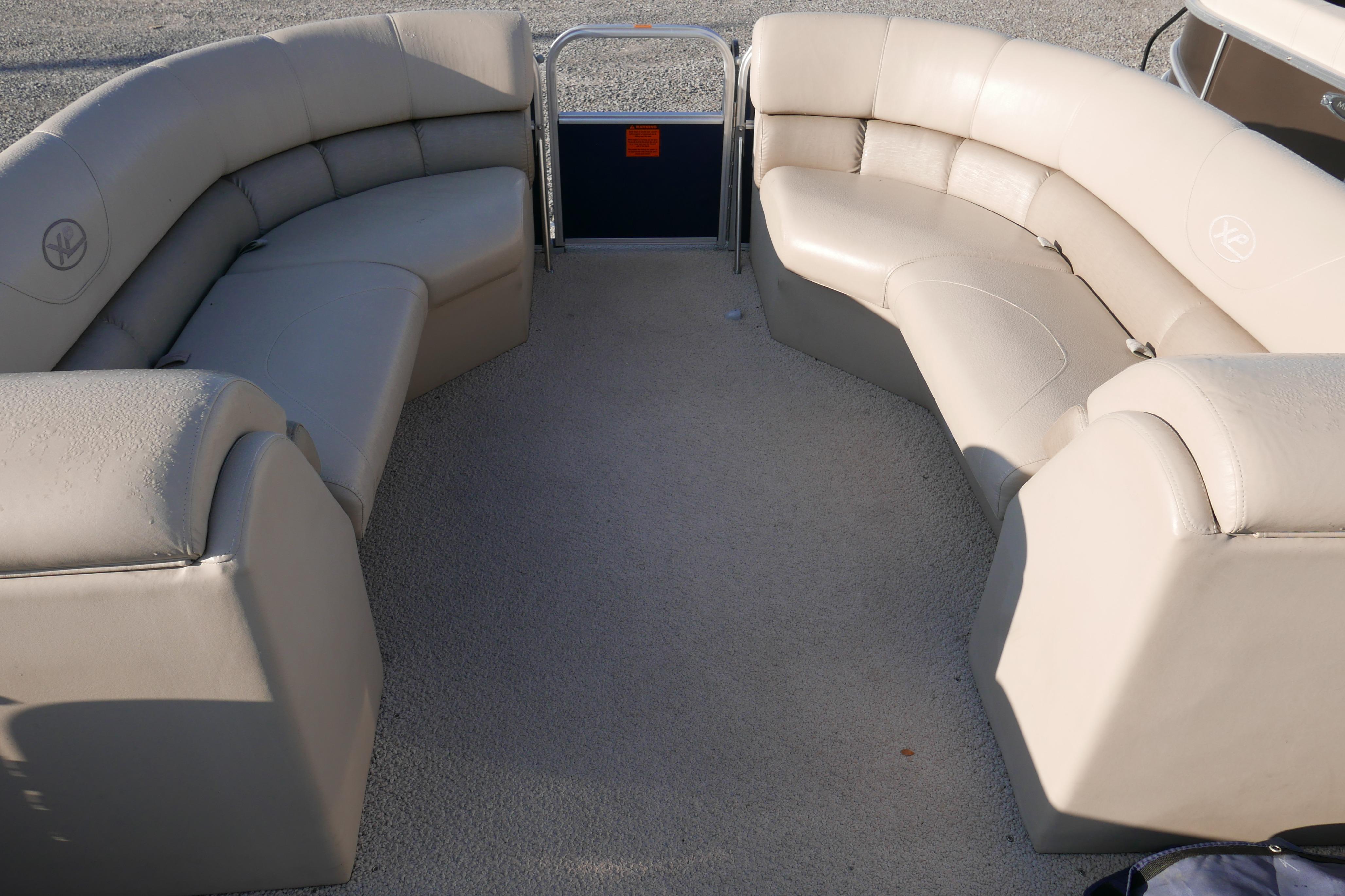 Luxurious seating on 2012 Xcusrion x2312 boat, featuring beige upholstery and spacious layout.