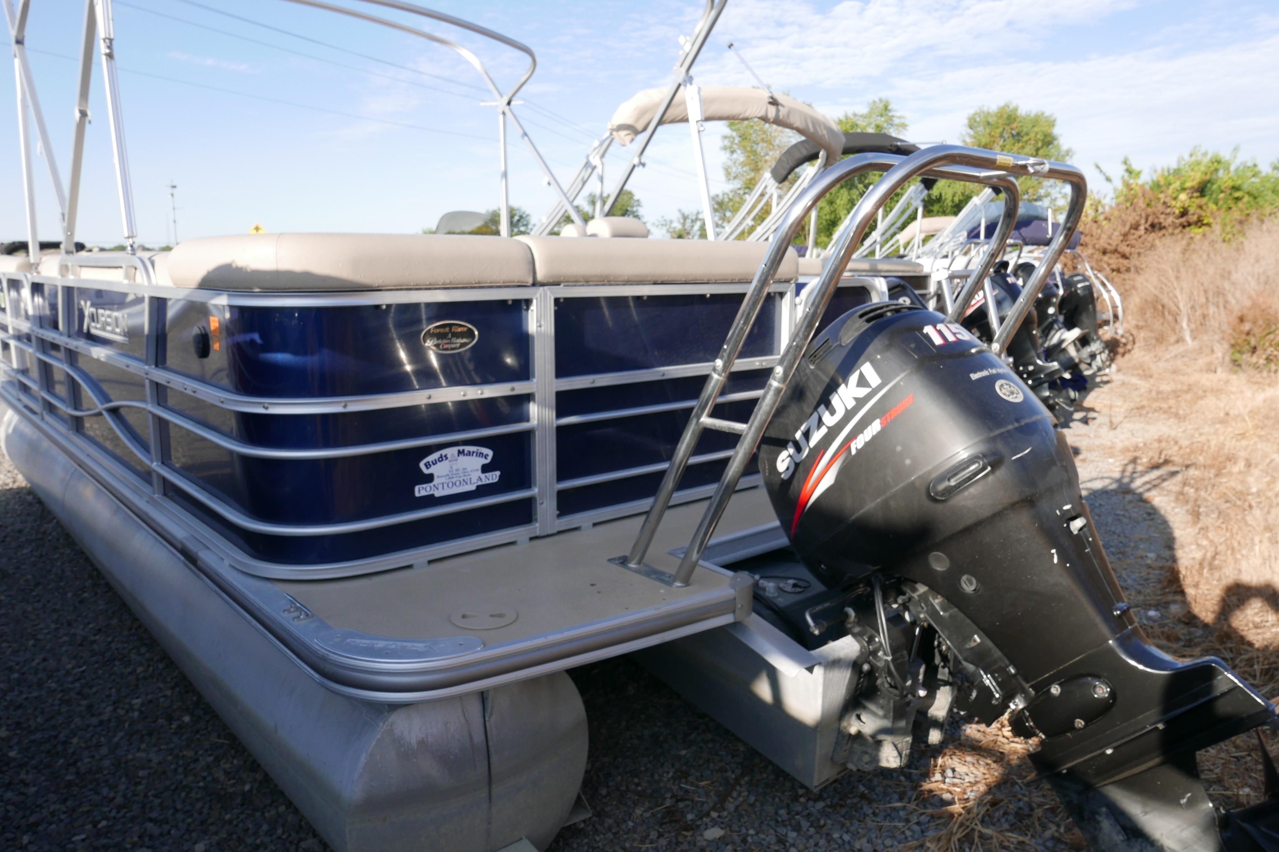 Pontoon boat Xcusrion x2312, 2012 model, with Suzuki outboard motor.