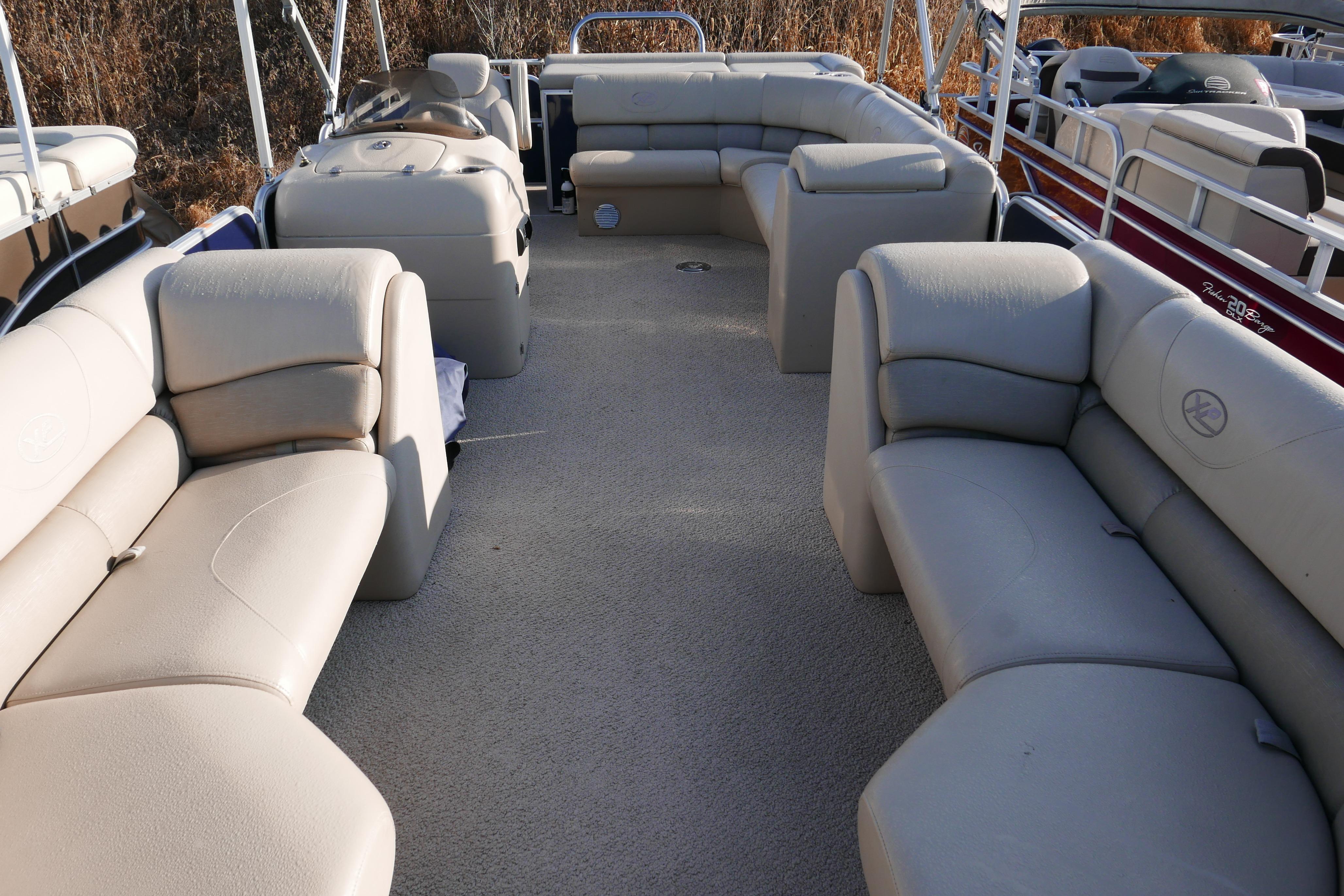Luxurious 2012 Xcusrion x2312 pontoon boat with spacious beige seating and modern design.