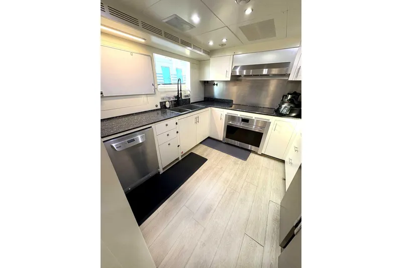 Namaste Yacht Photos Pics Modern kitchen in a 2013 Benetti Classic yacht, featuring sleek appliances and white cabinetry.