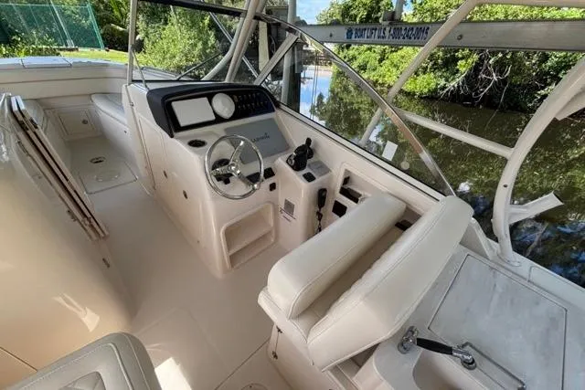  Yacht Photos Pics 2019 Grady-White Freedom 285 boat interior with helm and seating area.