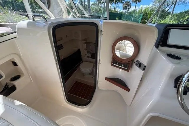  Yacht Photos Pics 2019 Grady-White Freedom 285 boat interior with compact bathroom and mirror.