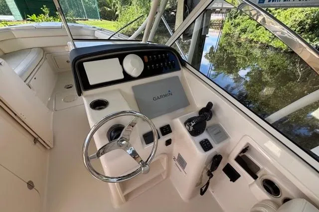  Yacht Photos Pics 2019 Grady-White Freedom 285 boat helm with Garmin navigation system and steering wheel.