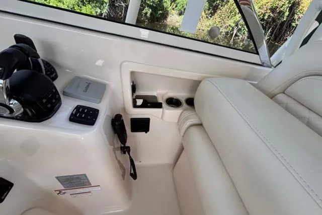  Yacht Photos Pics 2019 Grady-White Freedom 285 boat interior with controls and seating.