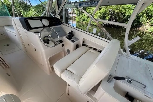  Yacht Photos Pics 2019 Grady-White Freedom 285 boat interior with helm, steering wheel, and seating.