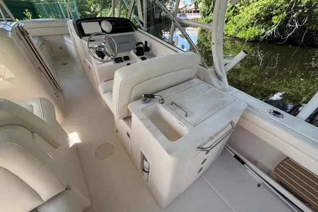  Yacht Photos Pics 2019 Grady-White Freedom 285 boat interior with helm, seating, and sink area.