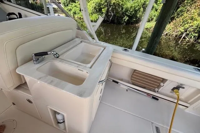  Yacht Photos Pics 2019 Grady-White Freedom 285 boat interior with sink and seating area.