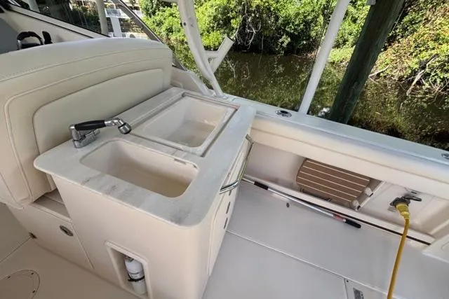  Yacht Photos Pics 2019 Grady-White Freedom 285 boat interior with sink and seating area.