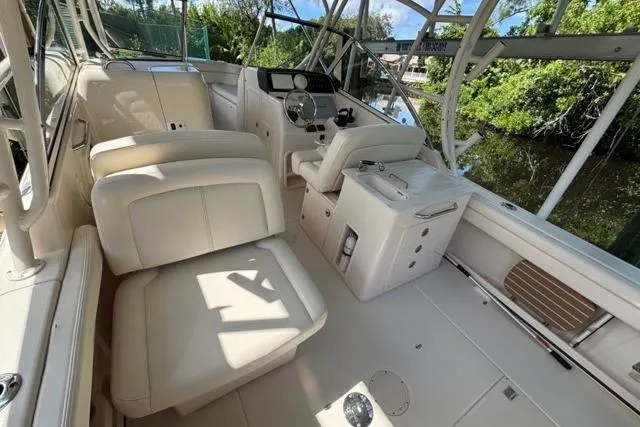  Yacht Photos Pics 2019 Grady-White Freedom 285 boat interior with plush seating and steering console.