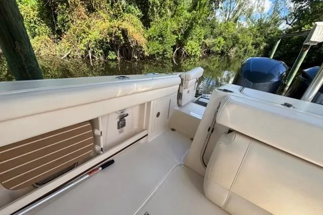  Yacht Photos Pics 2019 Grady-White Freedom 285 boat interior with lush greenery in the background.