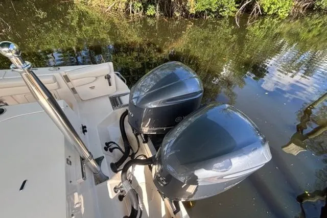  Yacht Photos Pics 2019 Grady-White Freedom 285 boat with dual outboard motors on calm water.