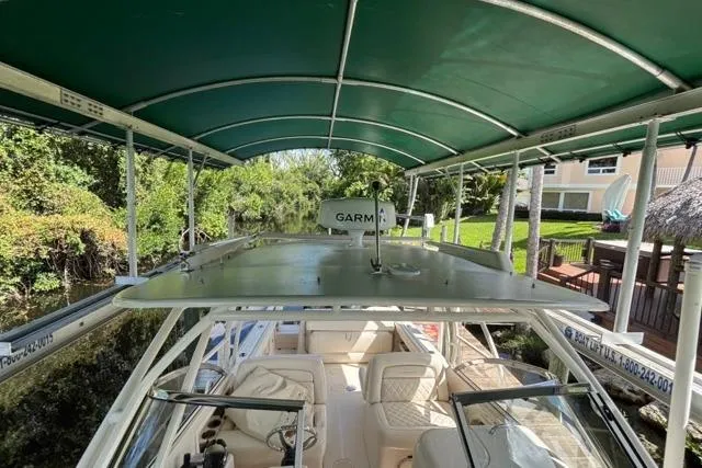  Yacht Photos Pics 2019 Grady-White Freedom 285 boat under green canopy, featuring Garmin equipment.
