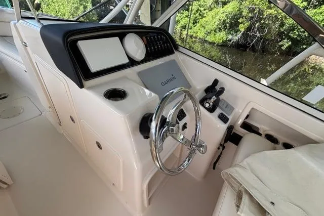  Yacht Photos Pics 2019 Grady-White Freedom 285 boat helm with Garmin navigation system and steering wheel.