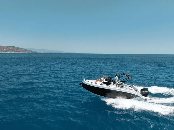  Yacht Photos Pics 2025 Ranieri NEXT 255 LX boat cruising on open sea under clear blue sky.