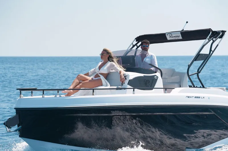  Yacht Photos Pics 2025 Ranieri NEXT 255 LX boat cruising with passengers on a sunny day.