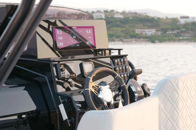  Yacht Photos Pics 2025 Ranieri NEXT 255 LX boat dashboard with modern controls and steering wheel.