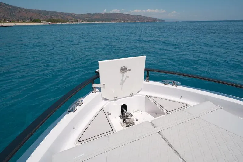  Yacht Photos Pics 2025 Ranieri NEXT 255 LX boat on clear blue water, showcasing deck and anchor storage.