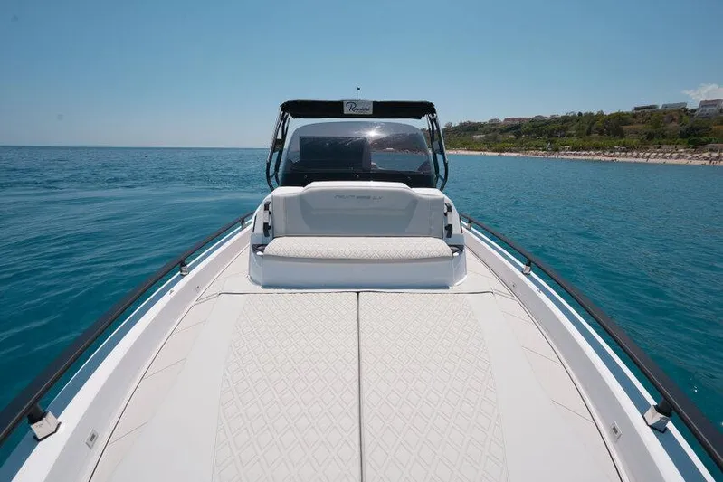  Yacht Photos Pics 2025 Ranieri NEXT 255 LX boat on calm sea, featuring sleek design and spacious deck.