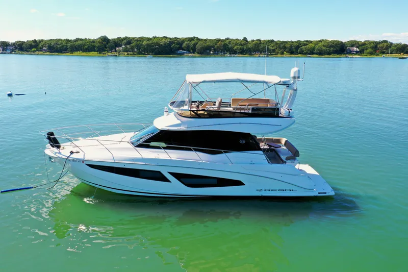 Blue Skies Yacht Photos Pics 2017 Regal 42 Fly yacht on calm water, showcasing sleek design and luxury features.