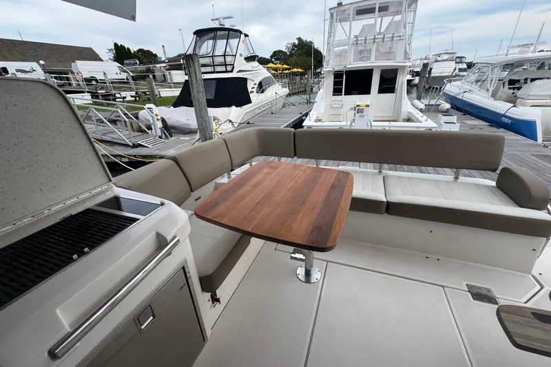 Blue Skies Yacht Photos Pics Luxurious 2017 Regal 42 Fly yacht with spacious seating and elegant wooden table.