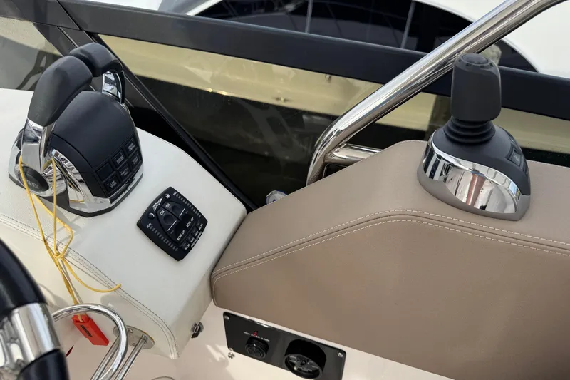 Blue Skies Yacht Photos Pics Control panel of a 2017 Regal 42 Fly yacht, featuring throttle and joystick controls.