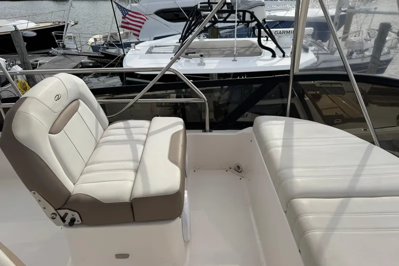 Blue Skies Yacht Photos Pics Luxury seating on 2017 Regal 42 Fly yacht, docked with American flag in background.