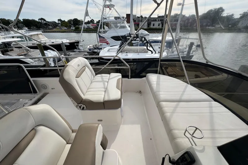 Blue Skies Yacht Photos Pics 2017 Regal 42 Fly yacht interior with white seating, docked at marina.
