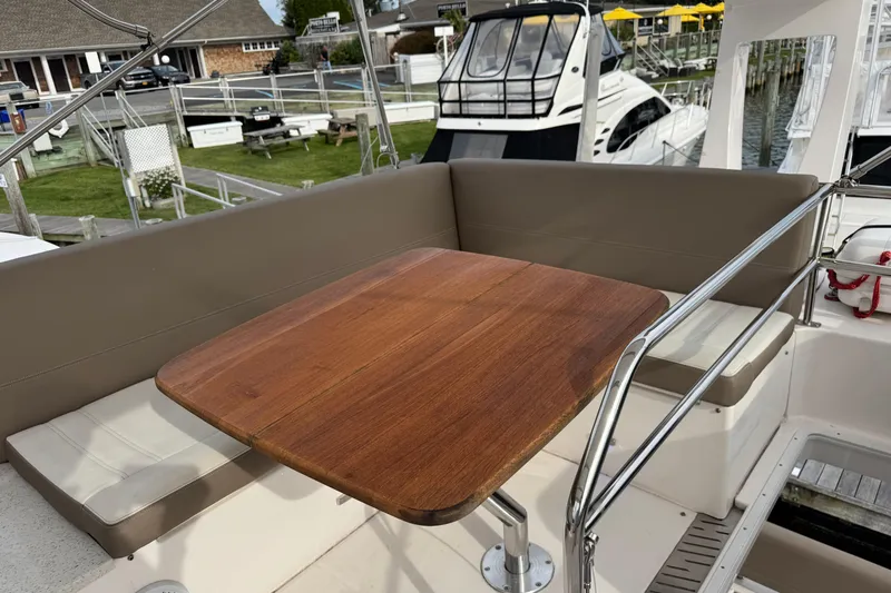 Blue Skies Yacht Photos Pics Cozy seating area on a 2017 Regal 42 Fly yacht with wooden table.