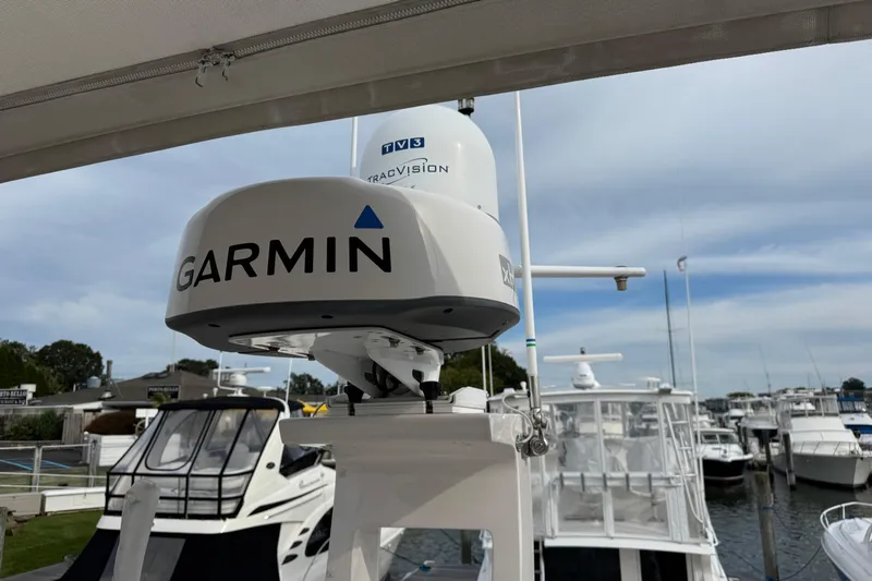 Blue Skies Yacht Photos Pics Garmin radar on 2017 Regal 42 Fly yacht at marina, clear sky background.