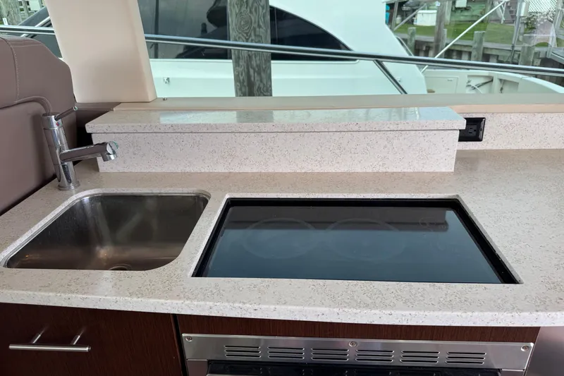 Blue Skies Yacht Photos Pics Luxurious 2017 Regal 42 Fly yacht kitchen with sink and stovetop.