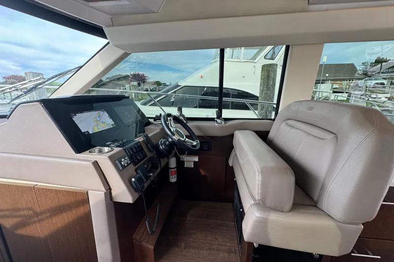 Blue Skies Yacht Photos Pics 2017 Regal 42 Fly yacht helm with modern navigation system and leather seating.