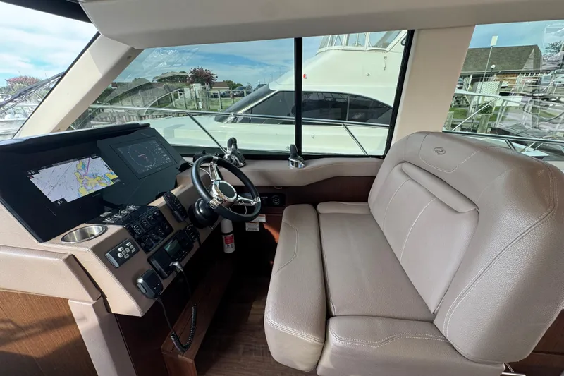 Blue Skies Yacht Photos Pics Helm of 2017 Regal 42 Fly yacht with navigation screens and leather seating.