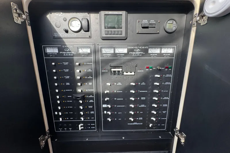 Blue Skies Yacht Photos Pics Electrical control panel of a 2017 Regal 42 Fly yacht, featuring various switches and gauges.